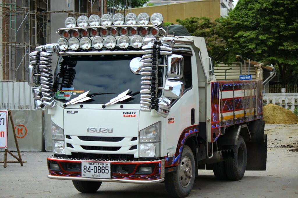 Decorative truck with chrome accents and vivid paintwork parked on a city street.